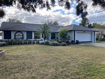 Front view of the house showcasing landscaping and a large yard at 4115 Kipling Ave, Plant City, FL 33566