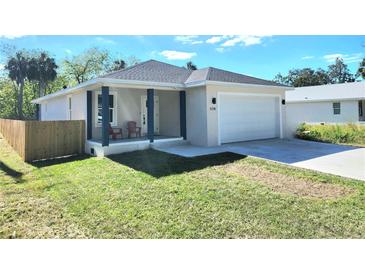 Charming single-Gathering home features a well-maintained lawn, inviting front porch, and convenient attached garage at 5714 Olive Dr, New Port Richey, FL 34652