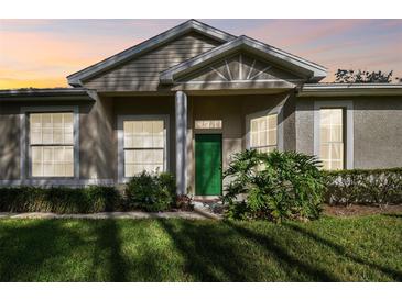 Charming house with green door and landscaped yard at 1687 Starling Drive, Tarpon Springs, FL 34689