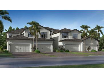 Modern townhouses with attached garages and lush landscaping at 19205 Cherrystone Way # 104, Lakewood Ranch, FL 34202
