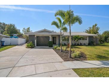 Charming single-story home featuring well-maintained landscaping, a two-car garage, and a modern, neutral color scheme at 13632 Imperial Groves S Dr, Largo, FL 33774