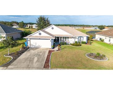 One-story house with a two-car garage and well-maintained lawn at 6887 Wirevine Dr, Brooksville, FL 34602