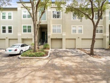 Townhouse with two-car garage and a spacious driveway in a lush setting at 760 Coral Reef Dr, Tampa, FL 33602