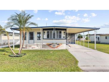 Single-Gathering home with carport and landscaped yard at 35209 Ada Ave, Zephyrhills, FL 33541