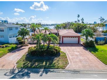 House exterior features brick driveway and waterfront view at 425 Capri Blvd, Treasure Island, FL 33706