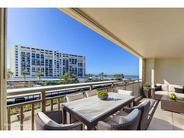 Balcony area features seating, tables, and beach views at 1430 Gulf Blvd # 204, Clearwater Beach, FL 33767