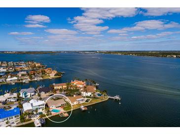 Aerial view of waterfront community featuring private docks, pools, and stunning water access at 825 116Th Ave, Treasure Island, FL 33706