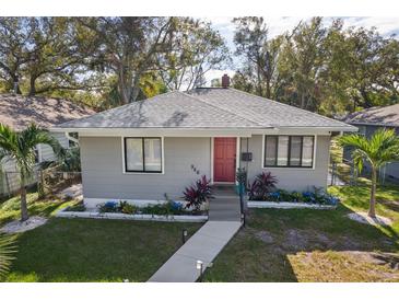 Gray house with red door, landscaping, and walkway at 946 23Rd S Ave, St Petersburg, FL 33705