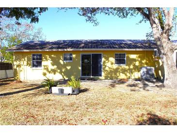 Back of the house showcasing a sliding glass door and AC unit at 12663 Eddington Rd, Spring Hill, FL 34609