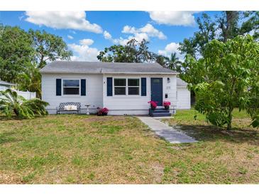 Charming single-story home with well-maintained lawn, walkway, and colorful flower accents at 215 35Th Ne Ave, St Petersburg, FL 33704