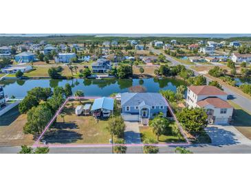 Aerial view of waterfront home with large lot and detached garage at 3295 Hibiscus Dr, Hernando Beach, FL 34607