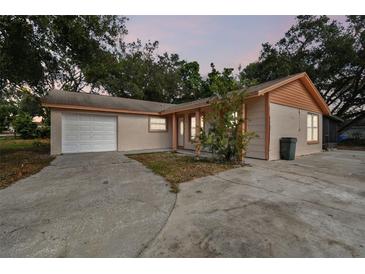 Newly renovated home with a brick facade, white garage door, and landscaped yard at 503 Avocado Cir, Brandon, FL 33510