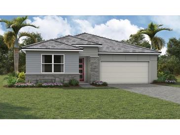 Single-story home with gray siding, stone accents, and a two-car garage at 11580 Myakka Blue Dr, Venice, FL 34293