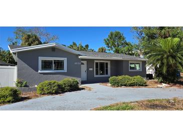 Charming single-story home featuring a gray exterior, well-maintained landscaping, and a cozy front entrance at 4659 Helena Ne St, St Petersburg, FL 33703