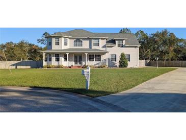 Two-story house with a large yard, driveway, and mailbox at 11305 Sweet Bay Ct, Riverview, FL 33569