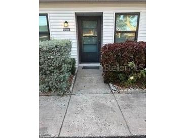 Inviting condo exterior with well-manicured landscaping and private entrance at 9218 Mission Oaks Blvd # E, Seminole, FL 33776