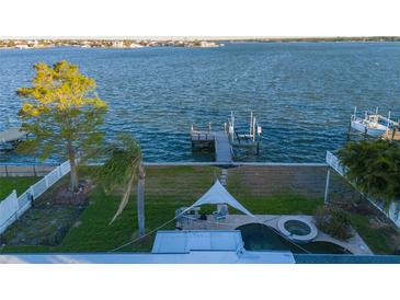 Aerial view showing waterfront home, private dock, and backyard oasis at 22 Paradise Ln, Treasure Island, FL 33706