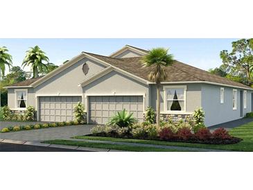 Two-story home with three car garage and landscaped front yard at 31526 Ancient Sage Rd, Wesley Chapel, FL 33545