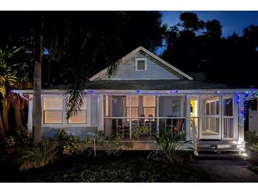 Charming bungalow with screened porch, festive lights, and landscaping at 485 11Th N Ave, St Petersburg, FL 33701