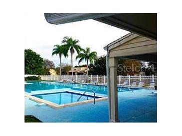A beautiful community pool offers a relaxing space, complete with palm trees and plenty of space to lounge at 6262 93Rd N Ter # 3904, Pinellas Park, FL 33782