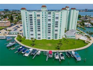 Stunning aerial view of a waterfront condo building with private boat slips and lush landscaping at 400 64Th Ave # 908, St Pete Beach, FL 33706