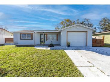 Updated single-story home with a freshly painted exterior, attached garage, and well-maintained lawn at 3226 Coldwell Dr, Holiday, FL 34691