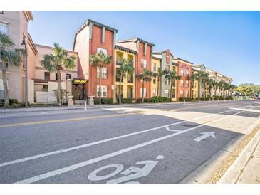 Multi-story building exterior with palm trees and bike lane at 2402 W Azeele St # 419, Tampa, FL 33609