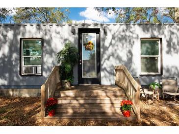 Modern container home exterior with wood deck and landscaping at 5021 69Th N Way, St Petersburg, FL 33709