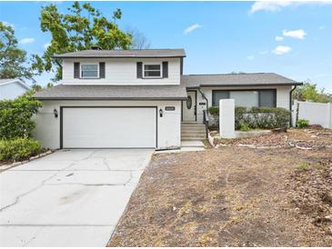 Attractive two-story home with a garage, a white exterior, and a landscaped front yard at 1601 Spring Ln, Brandon, FL 33510