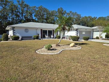 Single-story home with attractive landscaping and a two-car garage at 1707 New Bedford Dr, Sun City Center, FL 33573