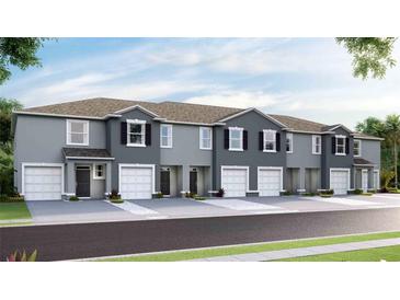 New townhouses with gray exterior, 2-car garages, and landscaping at 5038 Captain Davis Dr, Wimauma, FL 33598