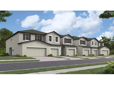 New townhouses with attached garages and landscaped lawns at 13244 Empress Jewel Trl, Parrish, FL 34219