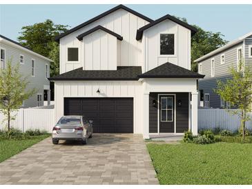 Two-story modern farmhouse with black accents and a paved driveway at 3819 71St N St, St Petersburg, FL 33709