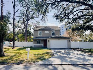 Charming two-story home with a well-manicured lawn and an attached two-car garage at 1102 W Charter St, Tampa, FL 33602