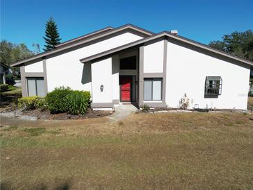 Charming single-story home with a red front door and neutral color palette at 1808 Cypress Trace Dr # 1808, Safety Harbor, FL 34695