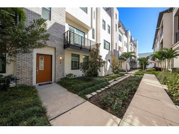 Modern townhome with a private entrance and landscaped courtyard at 2511 N Grady Ave # 55, Tampa, FL 33607