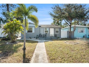 Gray brick house with a landscaped yard, walkway, and a small porch at 3510 1St S Ave, St Petersburg, FL 33711