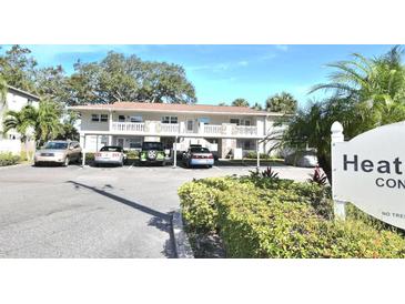Heather Lake Condominiums building with parking and landscaping at 930 Virginia St # 201, Dunedin, FL 34698