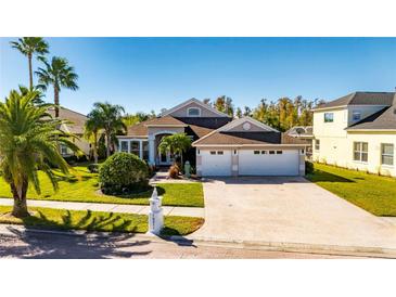 Beautiful two-story house with a three-car garage and manicured lawn at 10511 Martinique Isle Dr, Tampa, FL 33647