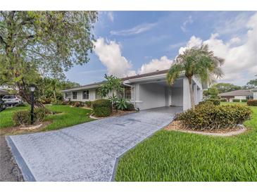 Single story home with carport and landscaped yard at 2025 Heathfield Cir # 2025, Sun City Center, FL 33573