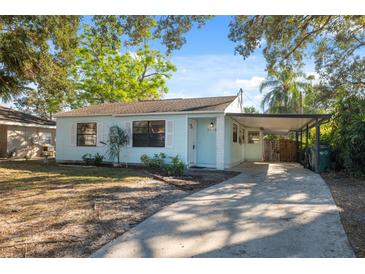 Light blue house with carport, driveway and well-maintained lawn at 3918 W Fig St, Tampa, FL 33609