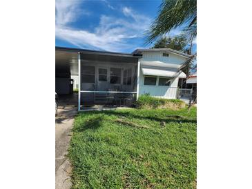 Mobile home exterior features carport and screened porch at 519 51St Avenue W Ter, Bradenton, FL 34207