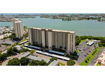 Aerial view of a waterfront high-rise building with parking and lush landscaping at 7050 Sunset S Dr # 405, South Pasadena, FL 33707