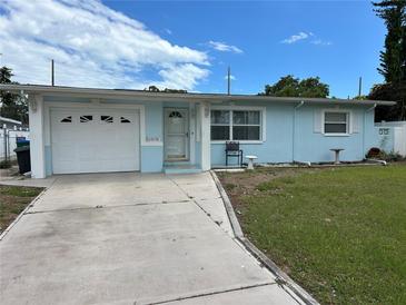Charming single-story home with a well-manicured lawn, garage, and inviting front entrance at 10170 64Th Ave, Seminole, FL 33772