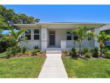 Charming single-story home with manicured lawn and a welcoming front porch with tropical landscaping at 2735 36Th N Ave, St Petersburg, FL 33713