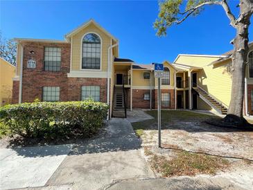 Brick condo building with stairs and landscaping at 8714 Mallard Reserve Dr # 104, Tampa, FL 33614