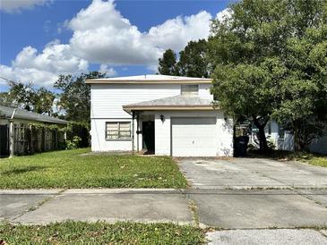 Two-story house with attached garage and a spacious front yard at 109 Biscayne Ave, Tampa, FL 33606