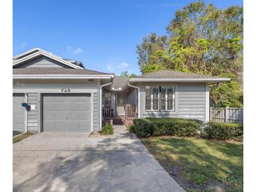 Gray two-story house with attached garage and landscaped yard at 725 Caya Costa Ne Ct, St Petersburg, FL 33702