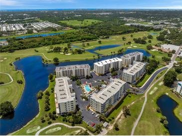 Aerial view of condo community near golf course and water at 1200 Country Club Dr # 3204, Largo, FL 33771