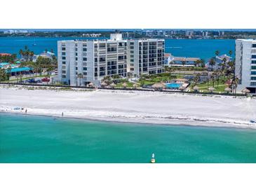 Beautiful aerial view of a beachfront condo with pool, sandy beach, and ocean views at 1400 Gulf Blvd # 801, Clearwater Beach, FL 33767